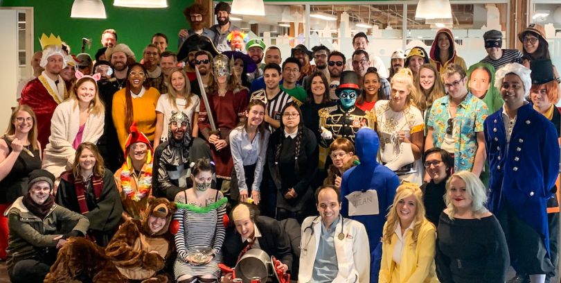 Neighborhoods.com staff posing during their Halloween party