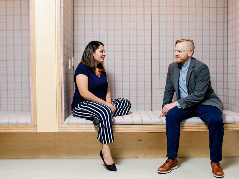Richa Rayamajhi talks with coworker Sam Bakken in the office.