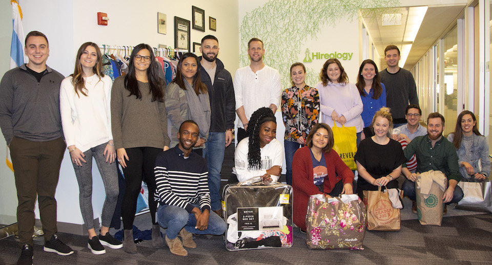 Hireology staff pictured with shopping bags of clothes for Dress for Success