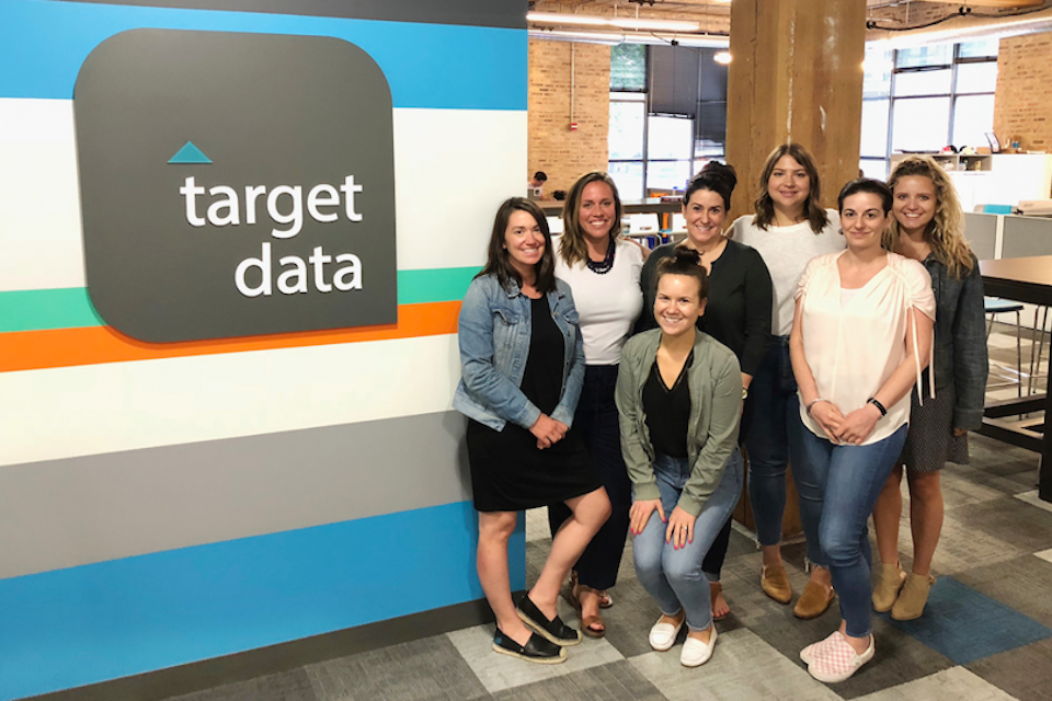 Target Data team posing near office logo