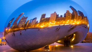 Chicago Cloud Gate shows reflection of the city at night.